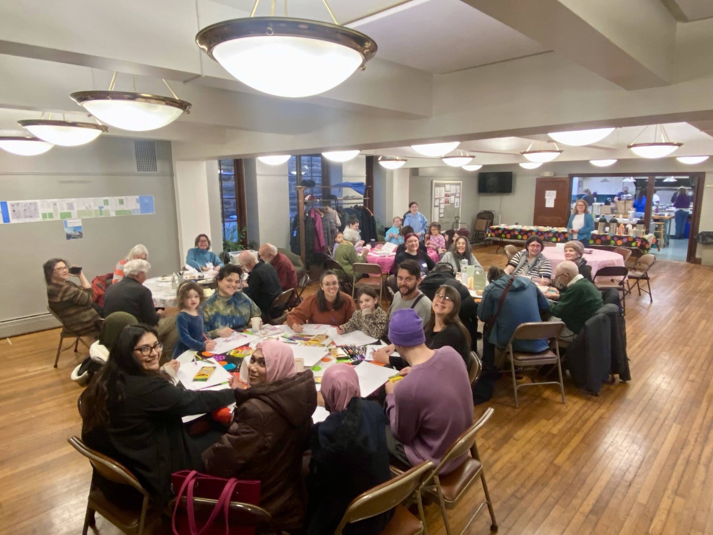 Families gathered around tables for crafts and fellowship